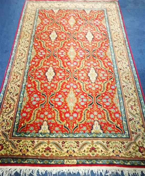 A Persian cream and red ground rug 220 x 132cm